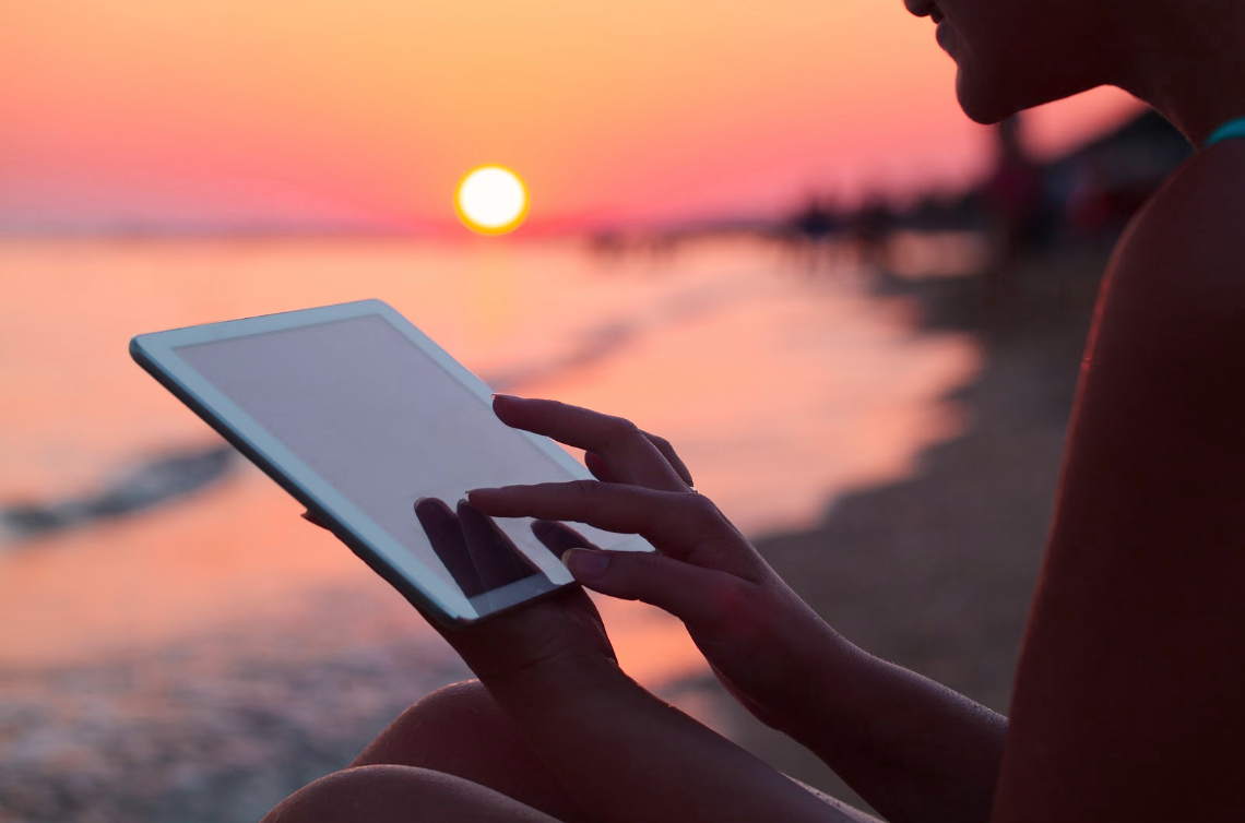 Beach image with person using tablet