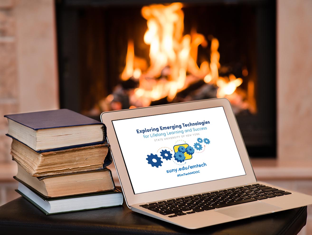 books in front of laptop & fireplace SM-Cropped shutterstock_183175220